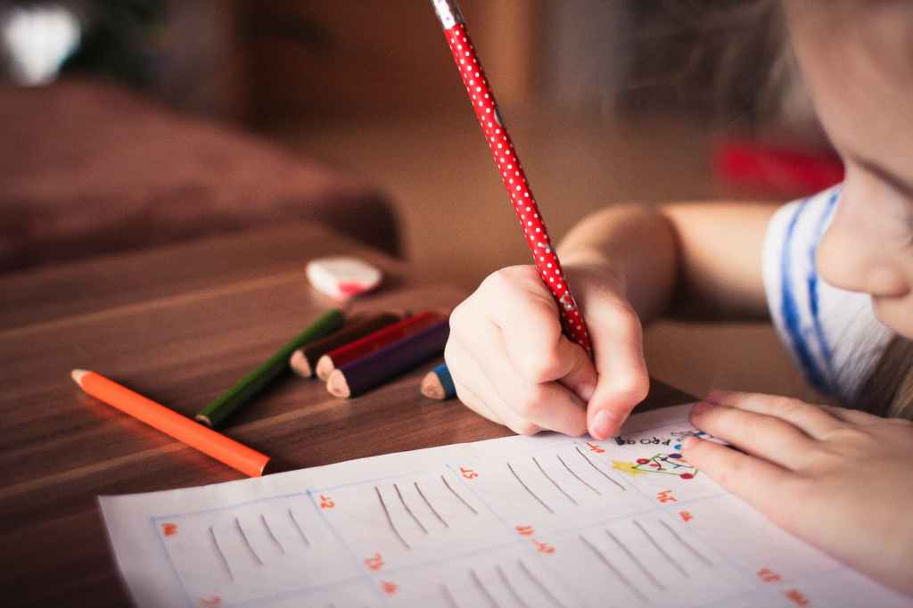 child writing in school